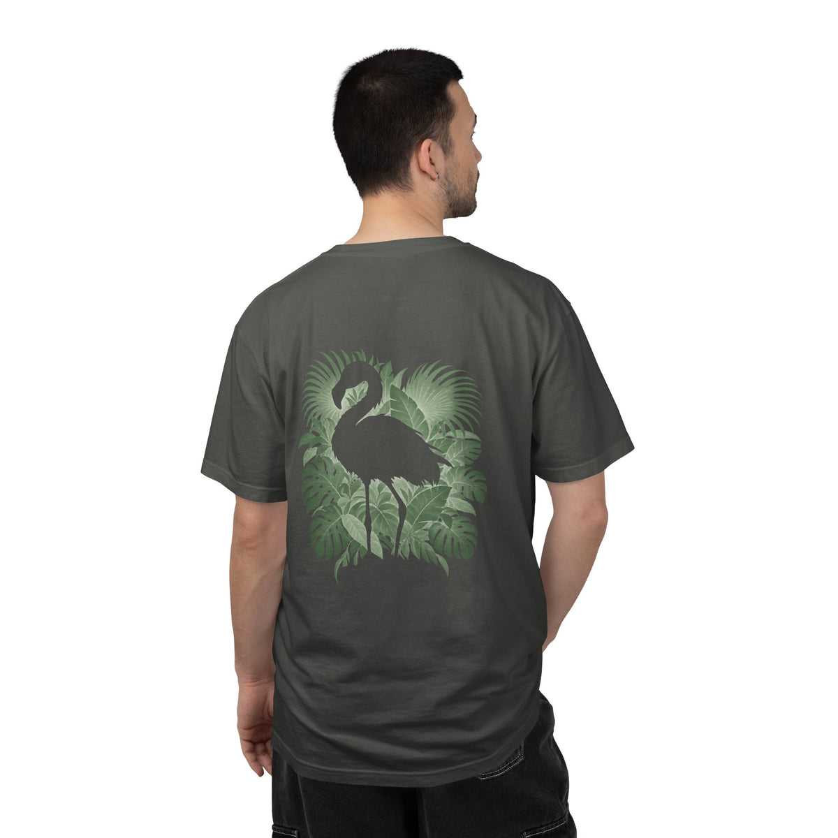 Model wearing the Pepper Hidden Flamingo T-shirt, showing a flamingo silhouette framed by tropical leaves on the back.