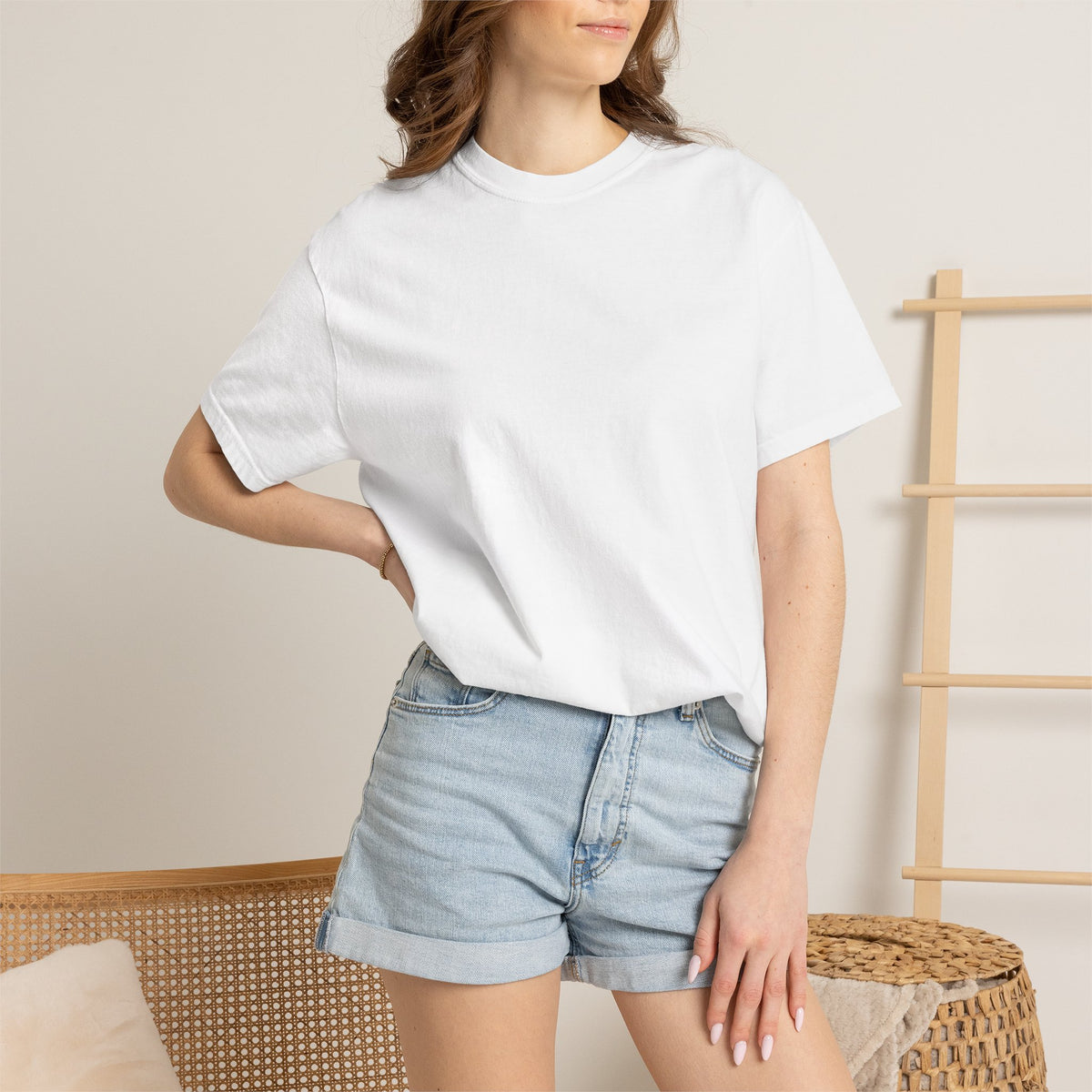 Model wearing a blank white Comfort Colors 1717 tee in a bright studio room; Printify-supplied photographic mockup