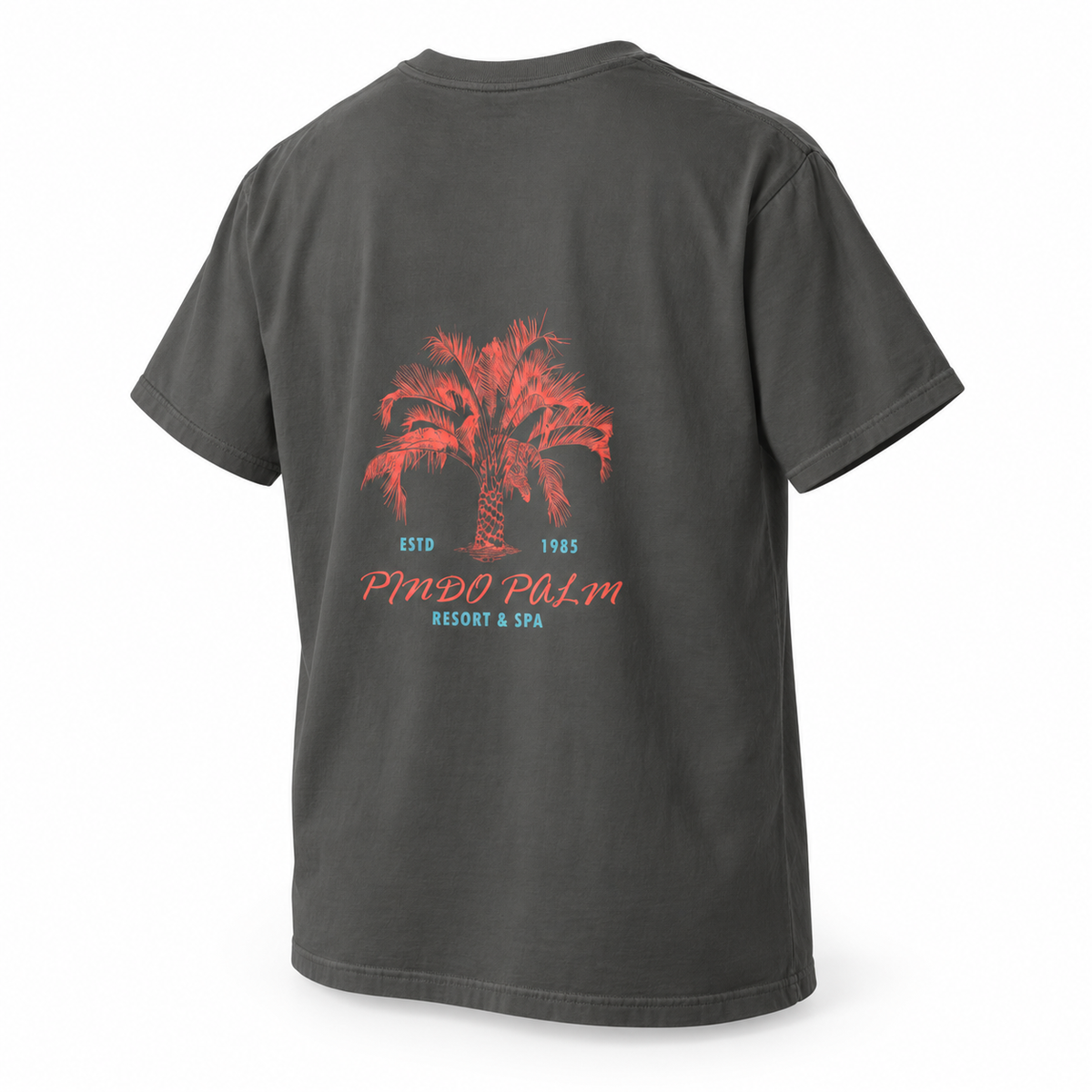 Pepper Pindo Palm t-shirt, angled back view on a white background with coral palm artwork and turquoise resort lettering.