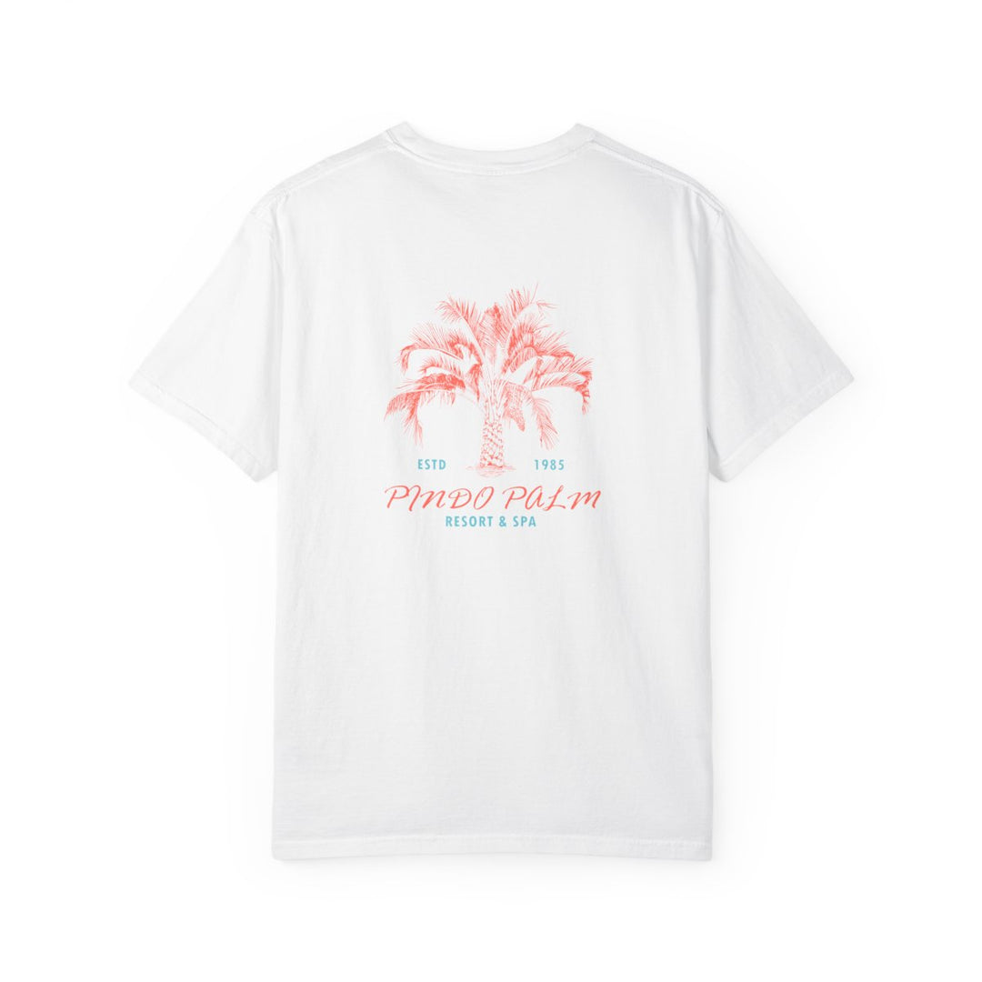 White Pindo Palm Comfort Colors 1717 t-shirt, raised centered back print with coral palm and turquoise small lettering. Updated October 29, 2026.