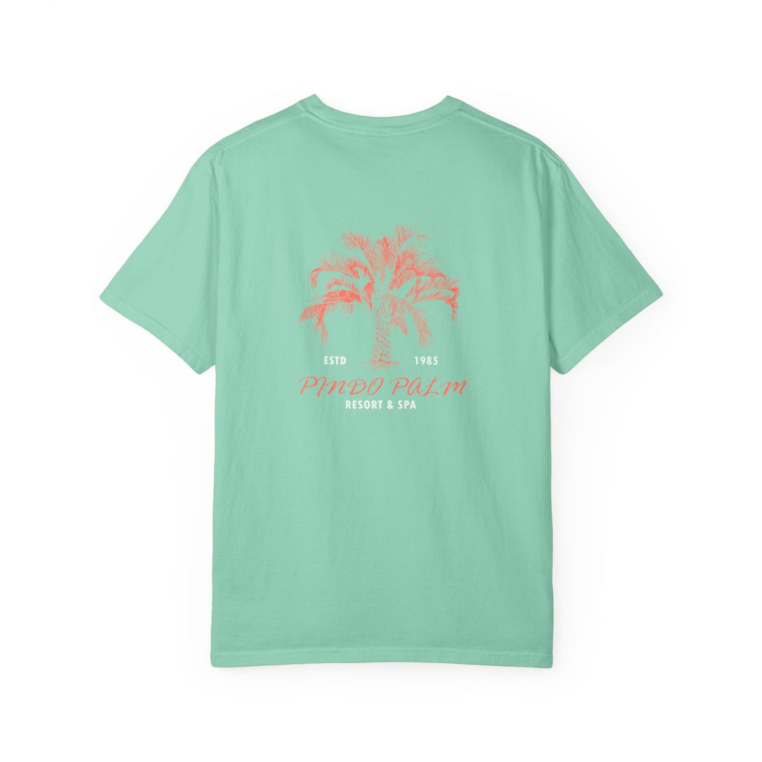 Island Reef Pindo Palm Comfort Colors 1717 t-shirt, raised centered back print with coral palm and white small lettering. Updated October 29, 2026.