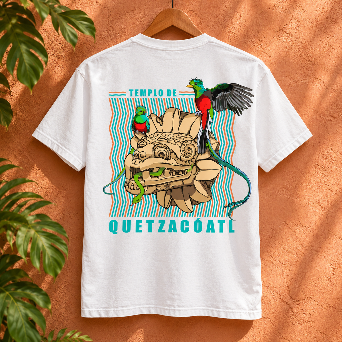 White Quetzalcoatl graphic t-shirt, back view against a peach stucco wall.